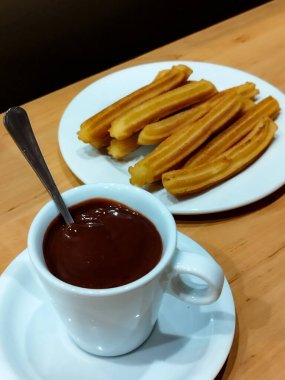 Chocolate with churros. Spanish churros with chocolate sauce. Cup of hot chocolate. Typical Spanish food clipart