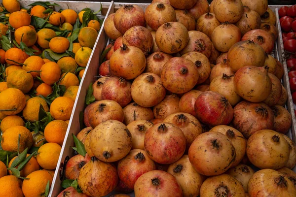 Street stall selling fruit and vegetables. Close-up of mandarins and onions