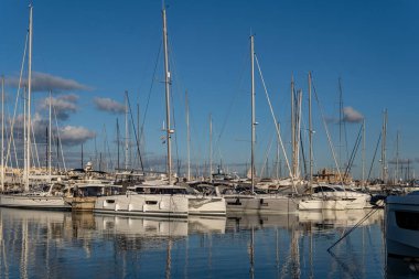 Palma de Mallorca, Spain; january 06 2023: Luxury yachts and sailboats moored in the harbor of the tourist city of Palma de Mallorca at sunset. Spain