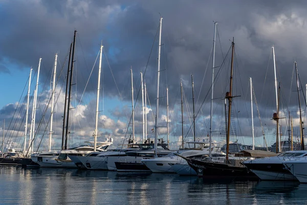 Palma de Mallorca, Spain; january 06 2023: Luxury yachts and sailboats moored in the harbor of the tourist city of Palma de Mallorca at sunset. Spain