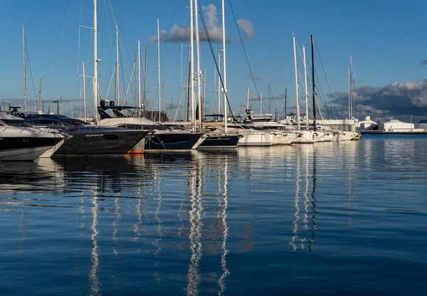Palma de Mallorca, Spain; january 06 2023: Luxury yachts and sailboats moored in the harbor of the tourist city of Palma de Mallorca at sunset. Spain
