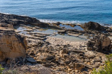 Old quarry of the Mallorcan mares stone, on the rocky coast of the Mallorcan town of Sa Coma at sunrise. Spain