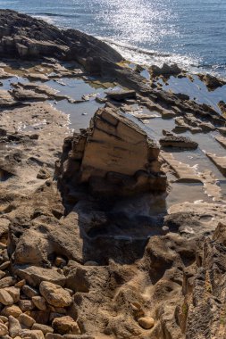 Old quarry of the Mallorcan mares stone, on the rocky coast of the Mallorcan town of Sa Coma at sunrise. Spain