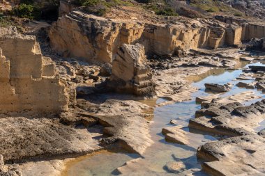 Old quarry of the Mallorcan mares stone, on the rocky coast of the Mallorcan town of Sa Coma at sunrise. Spain