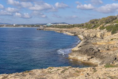 General view of the rocky coast of the Mallorcan tourist resort of Sa Coma, at sunrise. Island of Mallorca, Spain