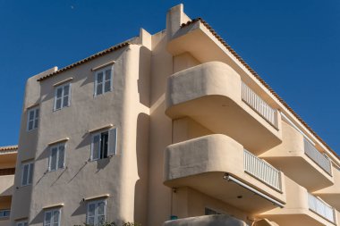 Sa Coma, Spain; february 17 2023: Main facade of a white hotel a sunny morning. Island of Mallorca, Spain