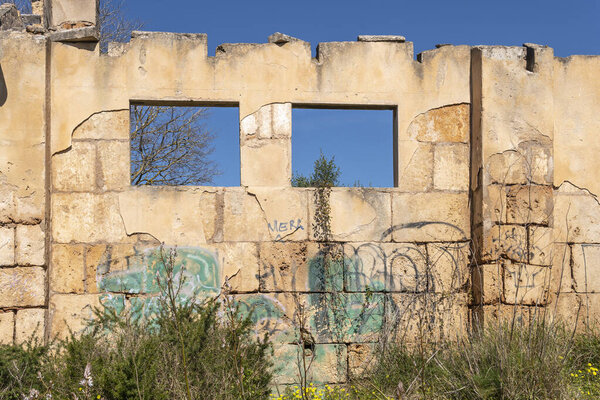 Santanyi, Spain; march 26 2023: Building in the middle of the countryside in a state of ruin and abandonment. Problem of the abandonment of the rural world in Spain. Santanyi, island of Mallorca