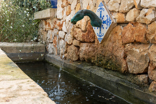 Ancient rural water fountain in the shape of a horse, in the interior of the island of Mallorca, Spain