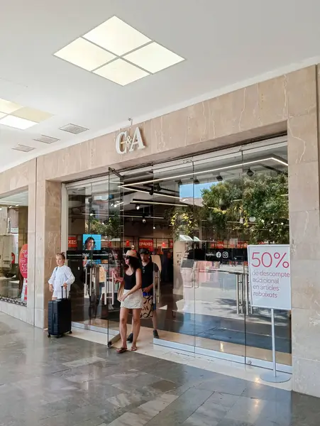 stock image Palma de Mallorca, Spain; august 09 2024: Main entrance of the multinational textile company C&A, with customers shopping on a sunny morning. Palma de Mallorca, Spain