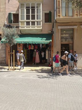 Palma de Mallorca, Spain; august 09 2024: Facade of a souvenir shop in the center of Palma de Mallorca, a sunny summer day with tourists clipart