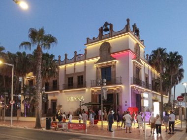 Palma de Mallorca, Spain; august 09 2024: Main facade of the famous Tabana restaurant, on the beach of Palma de Mallorca at dusk with tourists, one summer night clipart