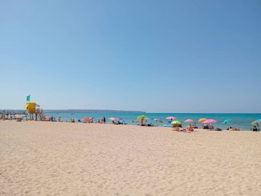 Palma de Mallorca, Spain; august 13 2024: General view of the beach of Palma de Mallorca with tourists on a sunny summer day clipart