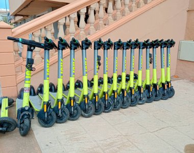 Palma de Mallorca, Spain; august 14 2024: Electric scooters of a rental company parked on the street in the Majorcan tourist resort of Playa de Palma de Mallorca clipart