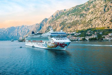 KOTOR, MONTENEGRO - SEPTEMBER 5, 2022: Cruise ship Norwegian Gem of NCL Norwegian Cruise line sailing away from Kotor, Montenegro. clipart