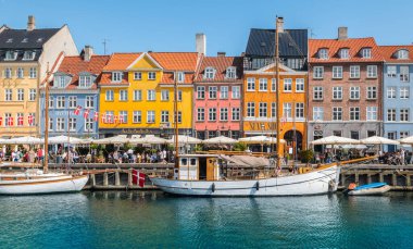 Copenhagen, Denmark - July 8, 2023: Colorful houses along the canal in Nyhavn, Copenhagen. clipart