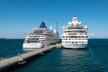 Tallinn, Estonia - July 24, 2023: Cruise ships Europa (Hapag-Lloyd Cruises) and Avitak (Aida Cruises) in port of Tallinn, Estonia. clipart