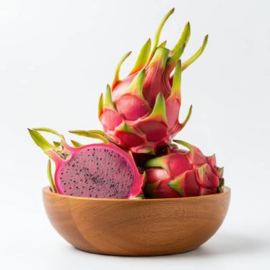 Vibrant dragon fruit chunks arranged neatly inside a wooden bowl over white setting clipart