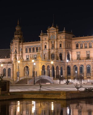 Main building in the Plaza de Espaa at night (Seville, Spain). Plaza de Espaa illuminated at night. Exterior faade of the city's most emblematic landmark.