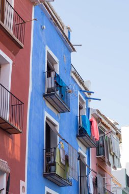 Building with coloured facade. Old building painted red and blue. Facade of a charming building.