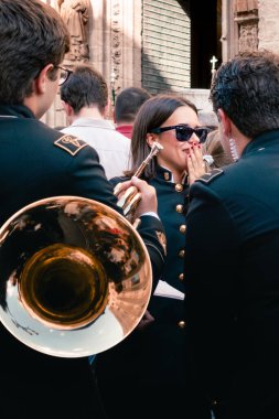 Seville, Spain; September 14th 2024: Musicians talking on the street during a musical parade. clipart