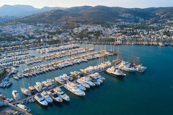 Aerial view of Bodrum city bay with many yachts and boats on a pear. Sea and town landscape of Milta marina in Turkey 