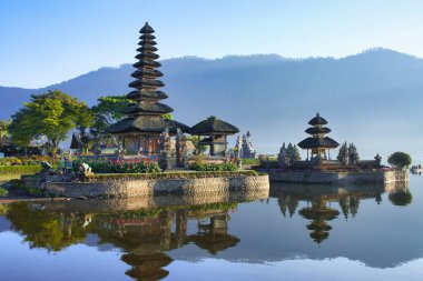 Morning view of Ulun Danu Beratan Temple on the lake. The most iconic and famous temple in Bali surrounded by mountains clipart