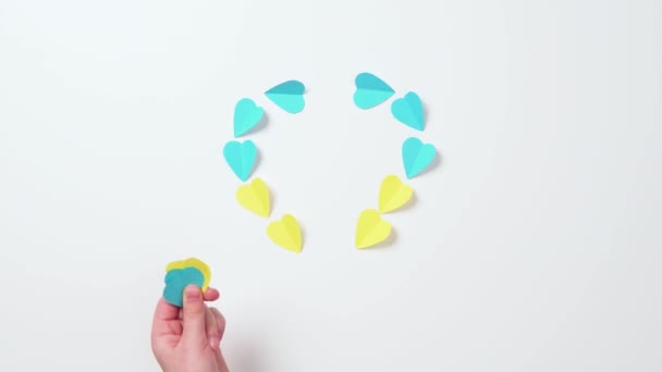 Children Hands Putting Colored Paper Hearts White Background Ukraine Yellow — Stock Video
