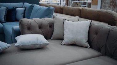 A brown sofa with beige cushions filmed in slow motion. 4k video.