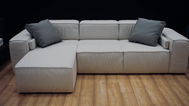 Modelo Sofá Branco Com Dois Travesseiros Cinza Piso Marrom Fundo — Vídeo de Stock