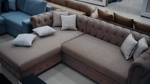 6つの白い枕が乱雑なスタイルで配置されたモダンな茶色のソファのトップショット 4Kビデオ 動画クリップ