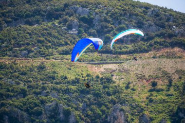Yaz günü içinde Dağların üzerinden uçan Yamaçparaşütü.