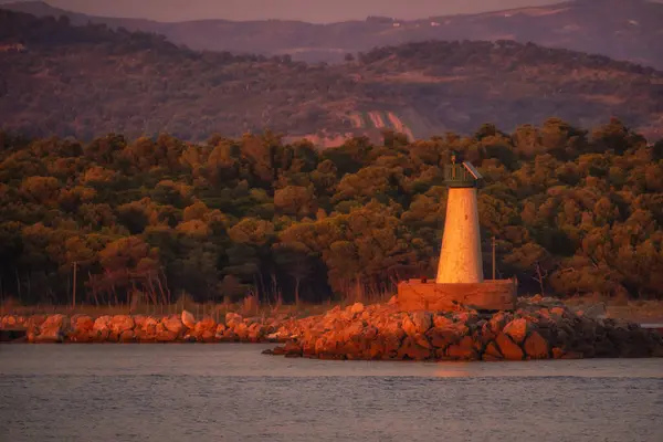 stock image A hot summer sunset over the Mediterranean Sea. lighthouse over a dramatic sunset.