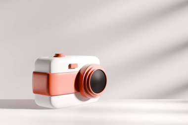 Beyaz ve pembe gövdeli üç boyutlu pastel renkli kamera beyaz bir yüzeyde oturur ve nötr bir arkaplanda minimalist ve modern bir kompozisyonda yumuşak gölgeler bırakır..