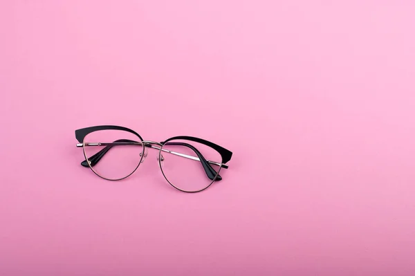 stock image Black frame eyeglasses isolated on pastel pink color background