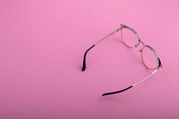 stock image Black frame eyeglasses isolated on pastel pink color background