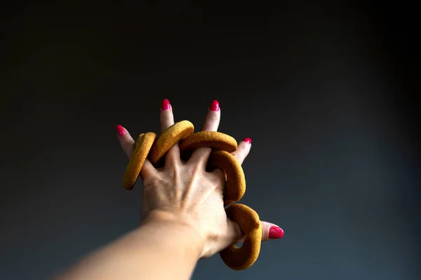 Masło Ciasteczkowe Pierścienie Palcach Dłoni Kobiety Szarym Tle — Zdjęcie stockowe