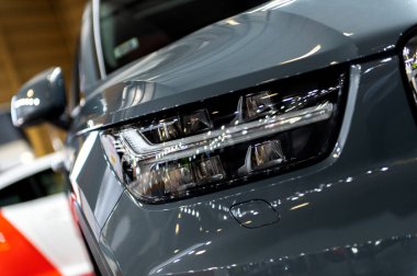 Riga, Latvia- April 29, 2022: Headlight of Volvo XC 40 Recharge Inscription T5 in Motor Show 2022