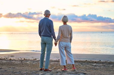 Yaşlı, zeki bir çift romantik bir şekilde deniz kenarında vakit geçirir. Birbirlerine nazikçe sarılırlar ve gün batımını izlerler..