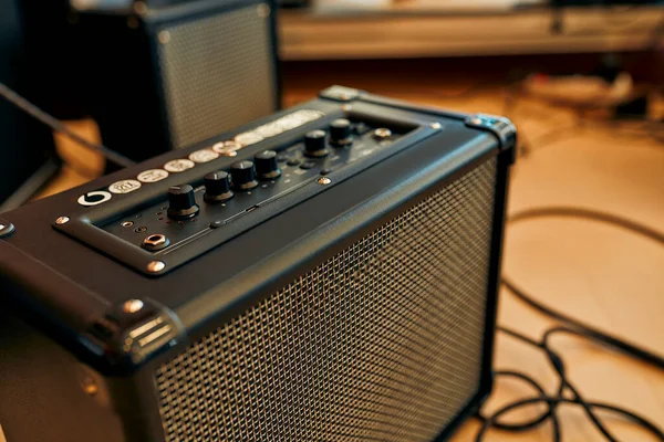Close-up of an electric guitar combo amp in a musical instrument store. Lots of different musical instruments for sale. Hobbies and recreation.
