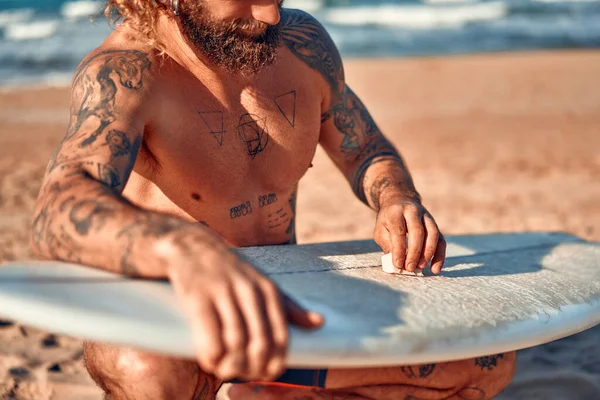 Bělošský Svalnatý Vousatý Muž Tetováním Plaveckých Trenýrkách Voskuje Surfovací Prkno — Stock fotografie