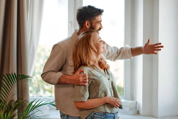Beautiful Adult Couple Hugging While Standing Window Living Room Home — Stock Photo, Image