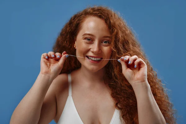 Freckled Redhead Plump Size Woman White Lingerie Flossing Isolated Blue — Stock Photo, Image