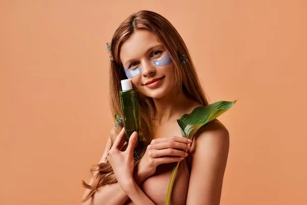 Mooie Vrouw Met Behulp Van Ooglapjes Met Een Fles Cosmetische — Stockfoto