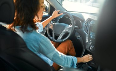 Yeni arabasını süren güzel, mutlu, genç bir kadın. Bir araba alıp kiralamak. Seyahat, turizm, eğlence..