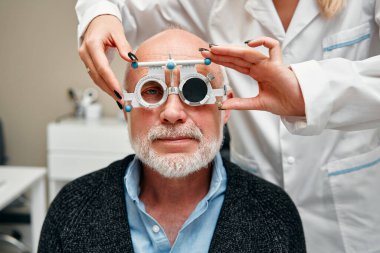 Görüş testi, tanılama ve görüş testi sırasında olgun bir erkeğe danışma. Göz bakımı, optometri hizmetleri ve görüş testi. Eleştiri kavramı, hizmet reklamları.