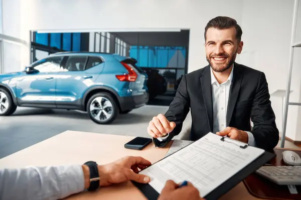 Salesman Suit Sitting Table Car Showroom Client Giving Forms Sign — Stock Photo, Image