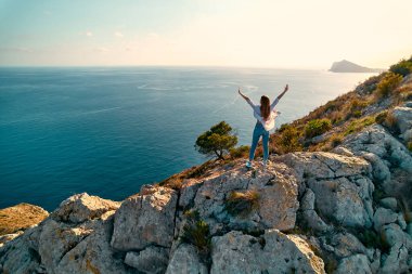 Calpe Comunidad Autonoma de Valencia, İspanya. Seyahat ve turizm. Okyanusun kıyısındaki bir şehirde uçurumun kenarında bir turist..