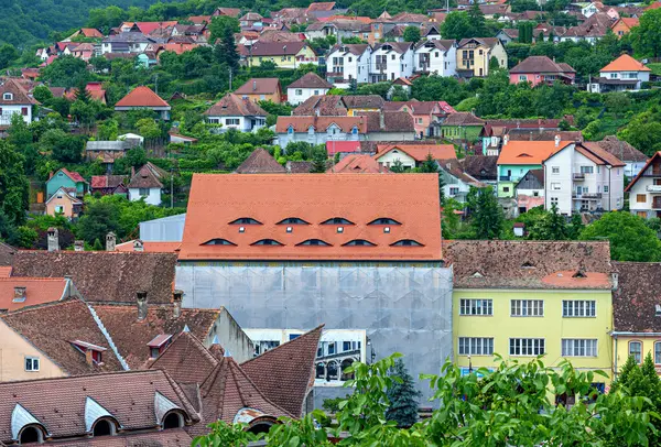 stock image roofscape of Sighisoara (Schaesburg) in Transsylvania with a house with roof hatches shaped like eyes, Romania