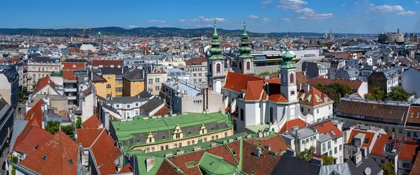 stock image panoramic view from the former flaktower (now House of the sea) north-west across the roofs of the 6th viennese district Mariahilf with the Mariahilf church until the mountains of the Viennese woods, Austria