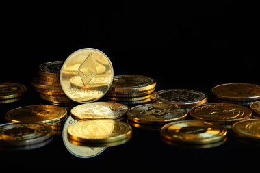 Ethereum kripto para birimi, karanlık bir yüzeyde daha fazla kripto para birimiyle çevrelenmiş ve benzersiz tasarımlarını ve logolarını gösteriyor..